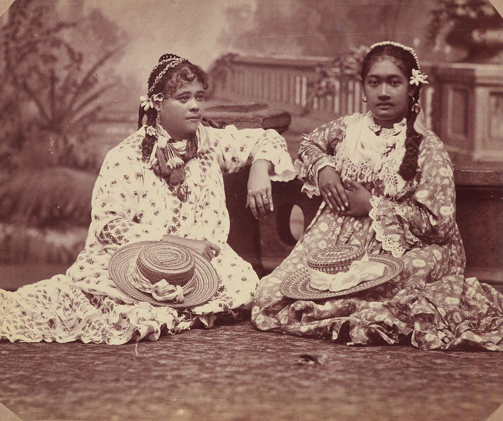 Two women sitting with hats in their laps. From the album: Tahiti, Samoa and New Zealand scenes (1885-1900).