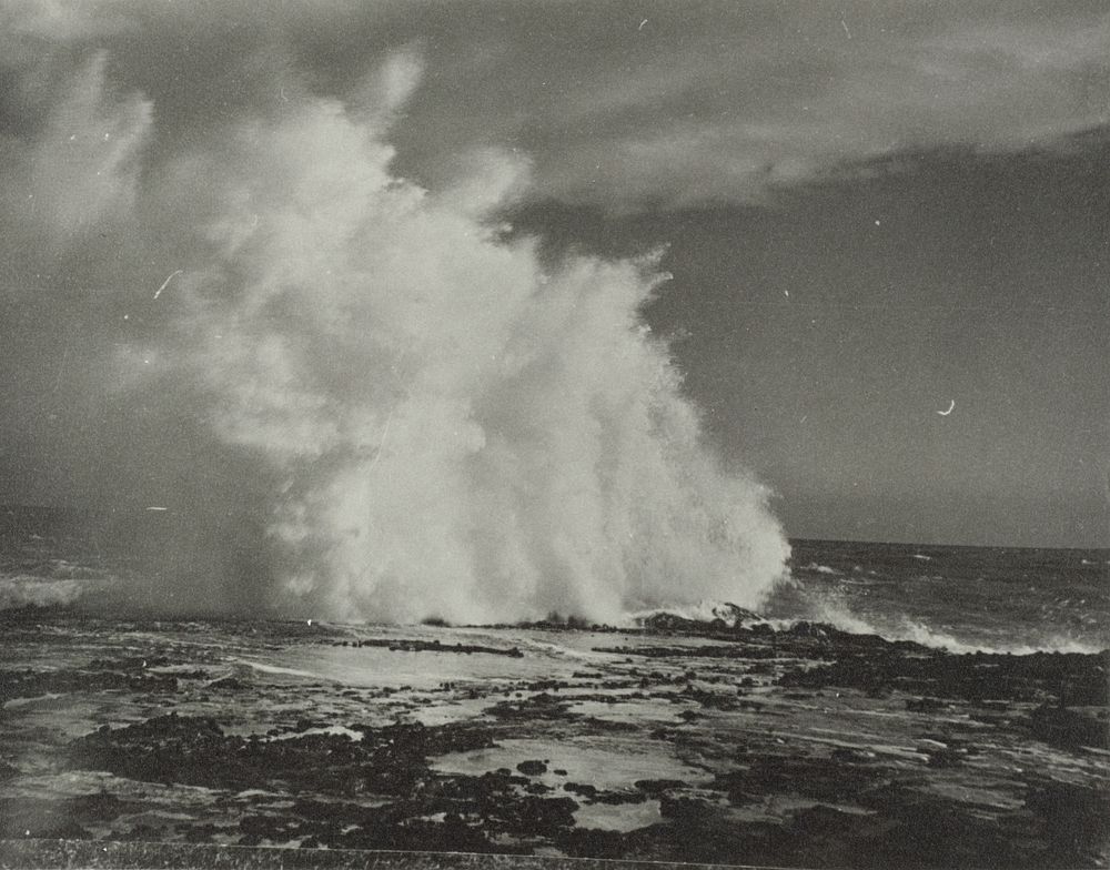 [wave crashing across rocks] (circa 1920).