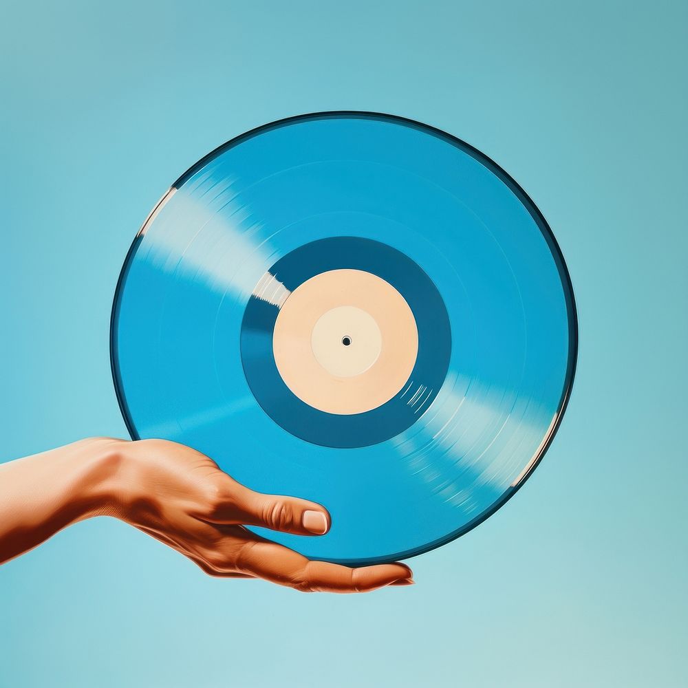 Hand holding a Vinyl record with a blank label isolated on clear solid background vinyl record gramophone technology. AI…