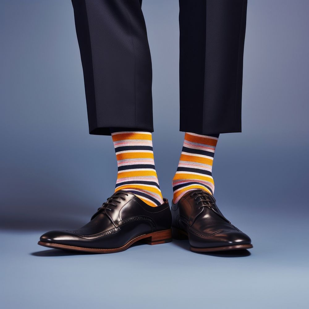 A person wearing a pair of shoes with striped socks footwear studio shot pantyhose. AI generated Image by rawpixel.