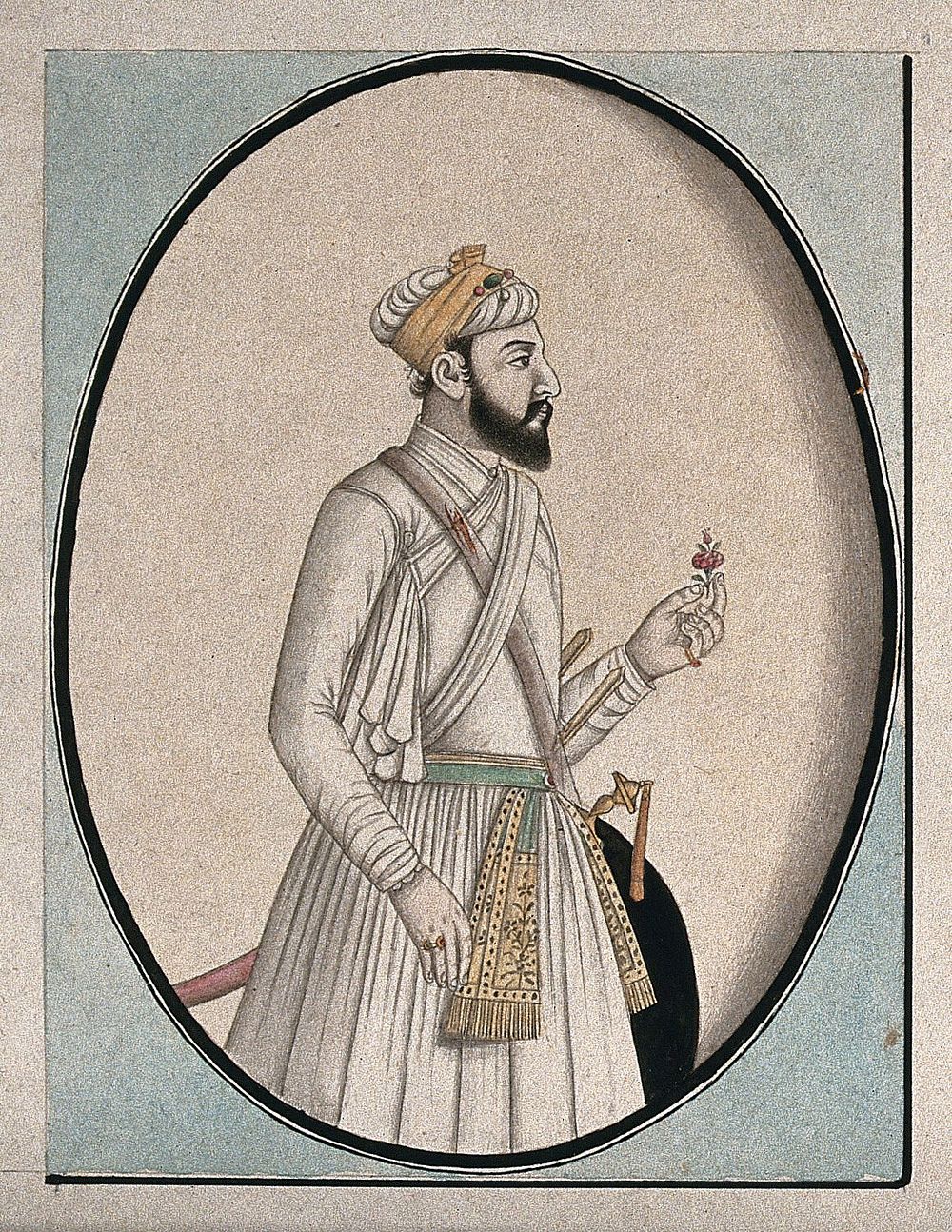 A Mughal courtier holding a flower. Watercolour drawing by an Indian artist.