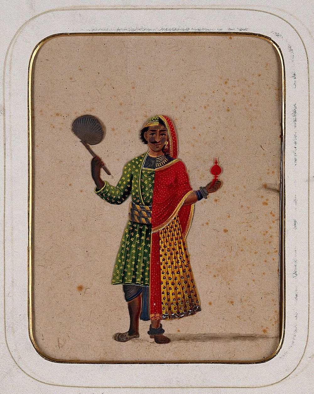A figure dressed as half male and half female, holding a fan in one hand and a ritual object in the other. Gouache painting…