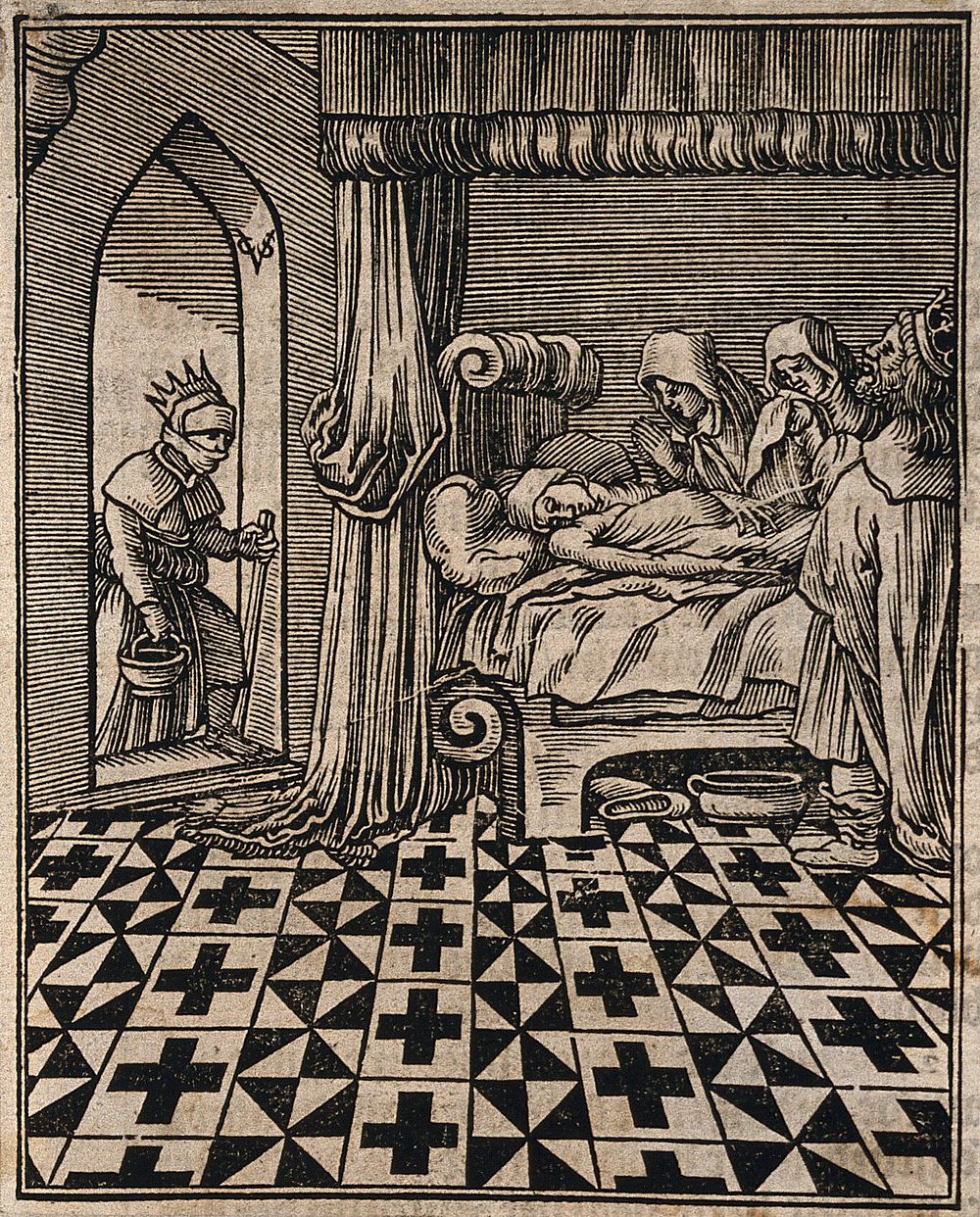 Two hooded figures and a king grieve over a dead person while a masked woman enters the room with a bowl and a stick.…