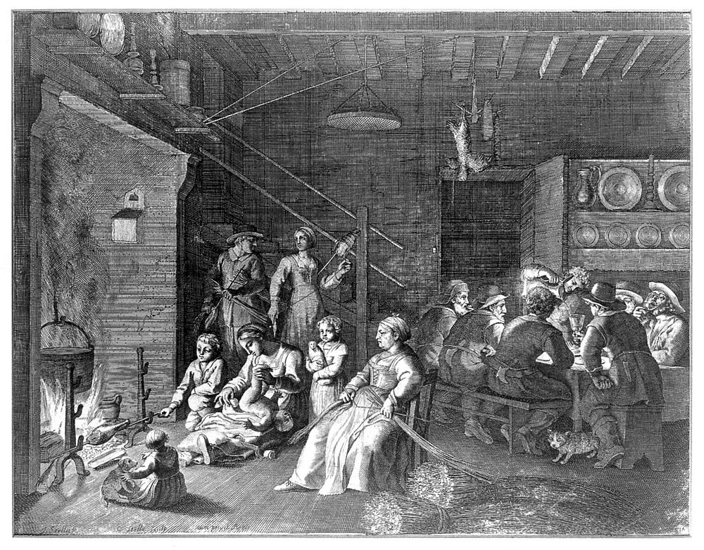 A communal house, the men sit drinking around a table while the women look after the children, weave hay and the older…