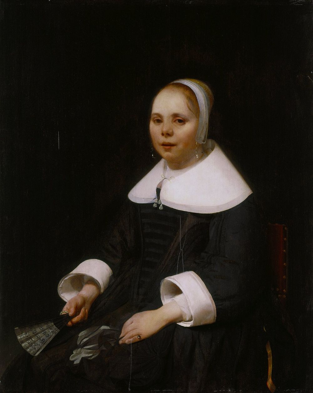 Dutch golden age. Three quarter length figure of a young woman in black, seated toward the left, but looking at the viewer.…