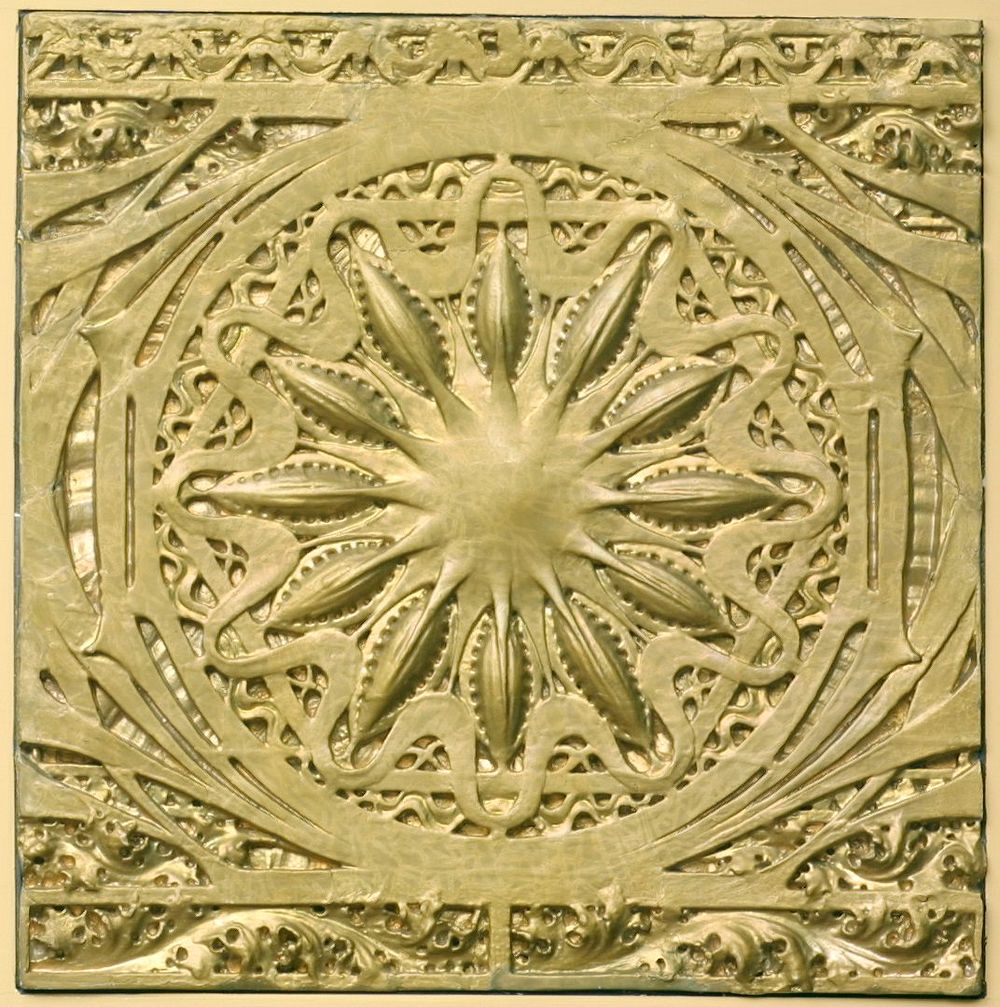 Flower-like central medallion surrounded by organic motifs; mounted to a plywood backing. Original from the Minneapolis…