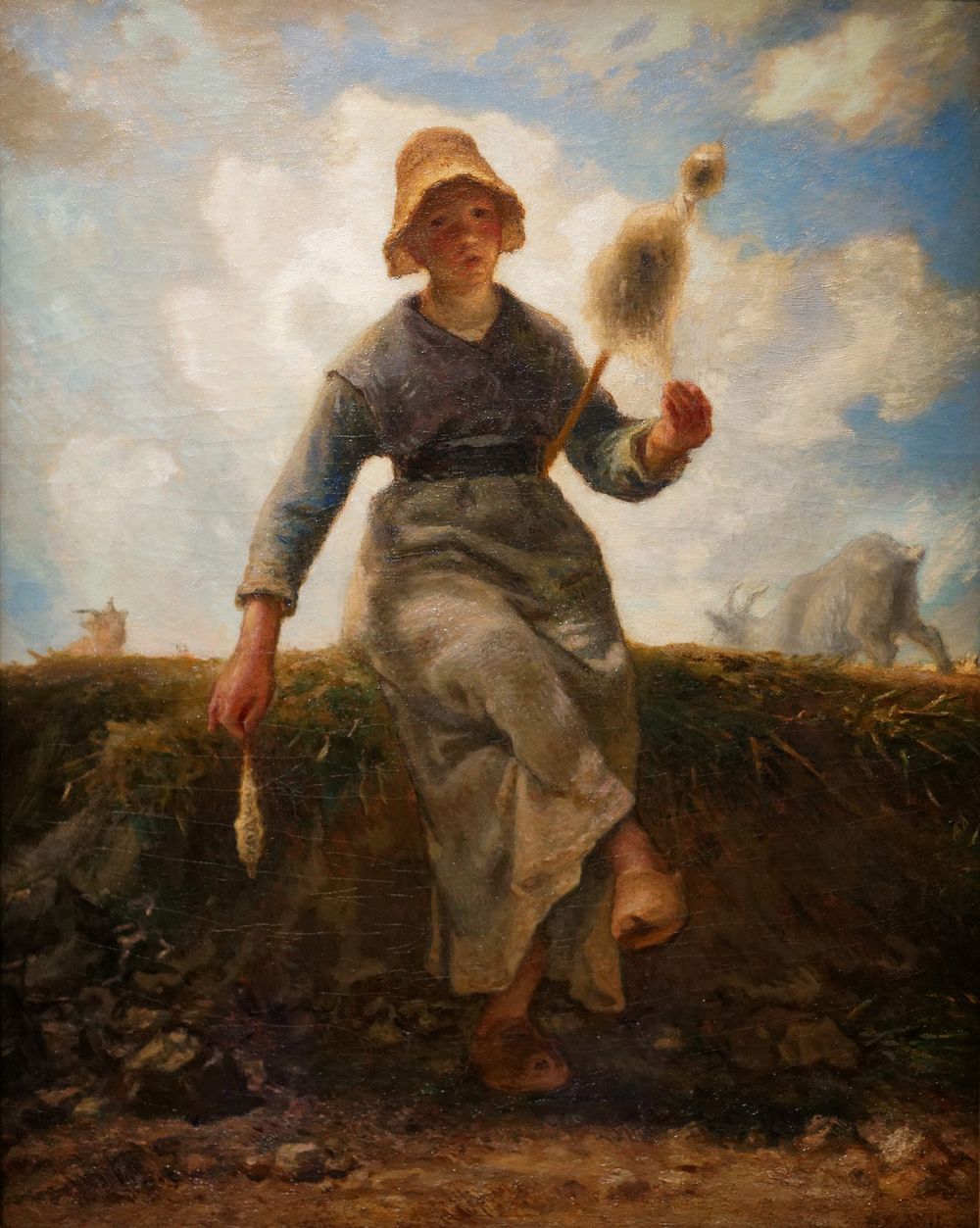 Naturalist portrait depicting a young peasant girl, spinning a length of wool by Jean-Fran&ccedil;ois Millet