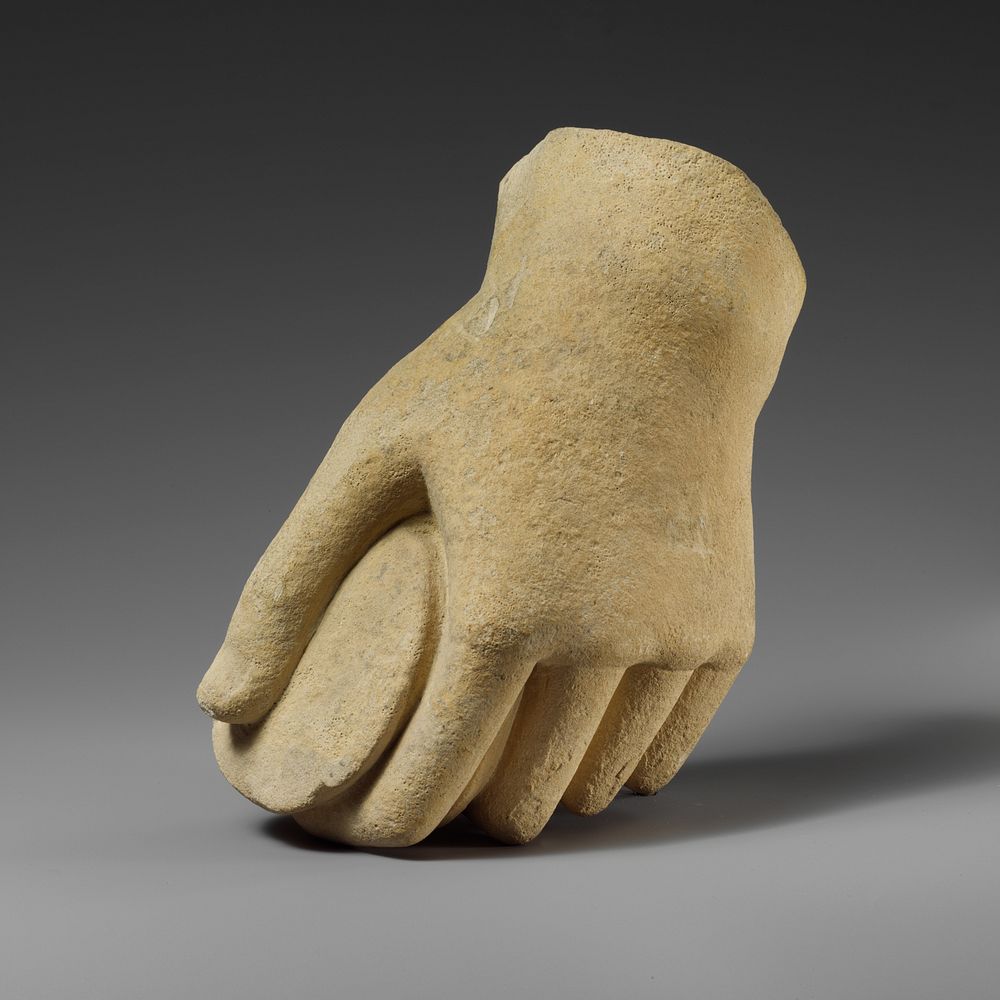 Limestone hand holding a pyxis