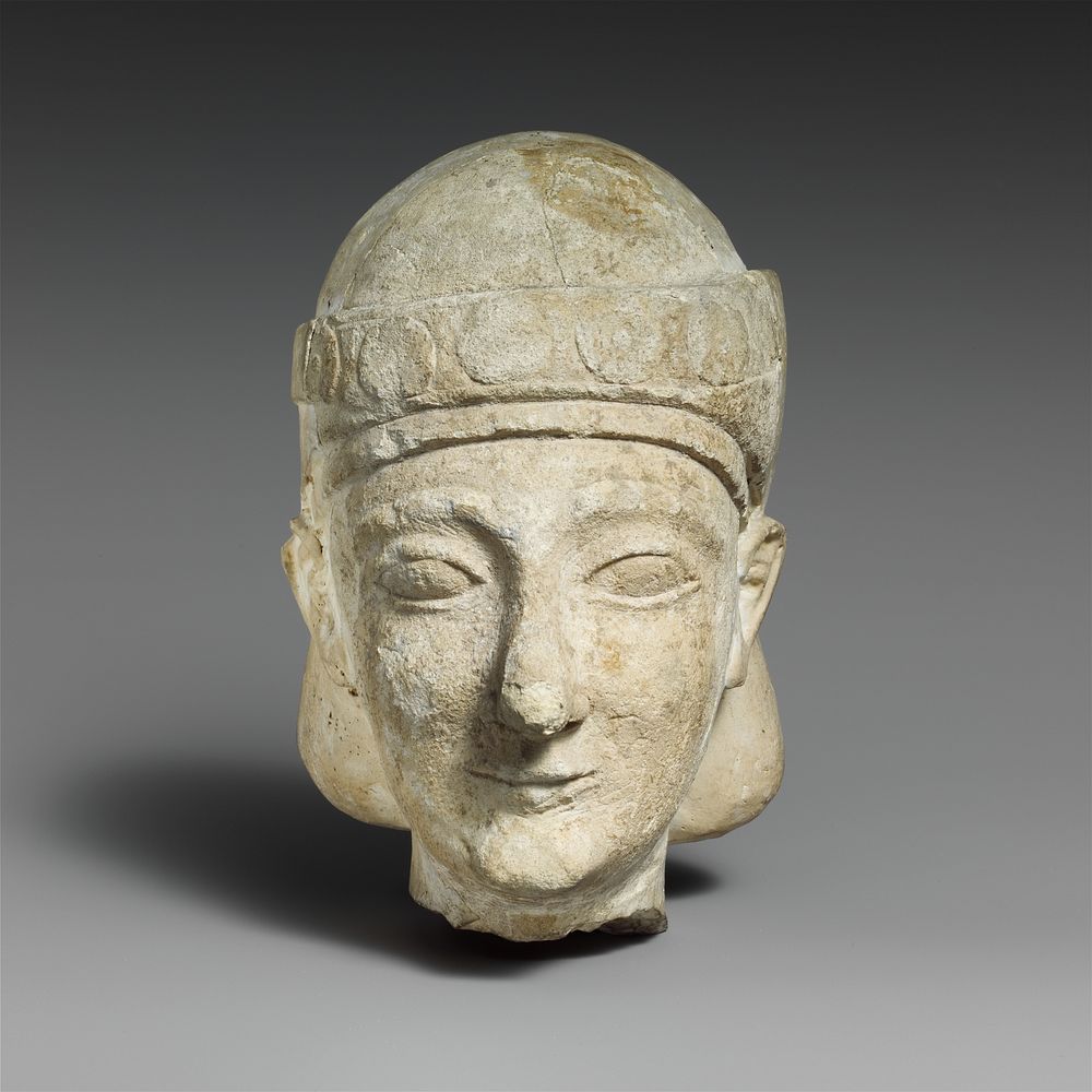 Limestone head of a beardless male with a diadem