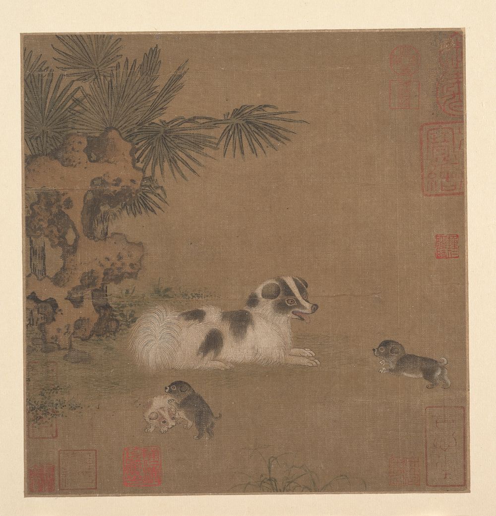 Puppies Playing beside a Palm Tree and Garden Rock by Unidentified artist