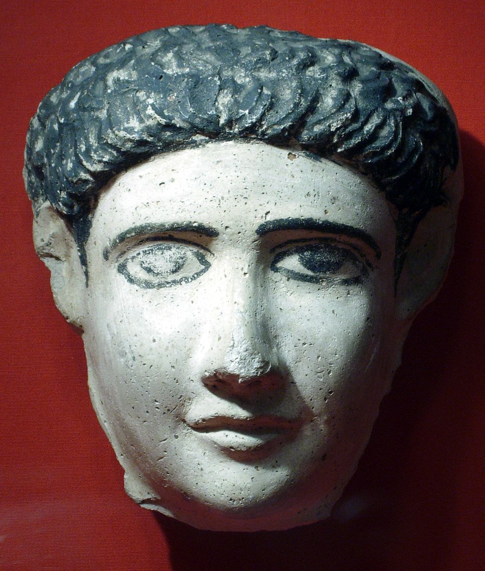 Small mask, possibly of a boy, with short locks combed to the front