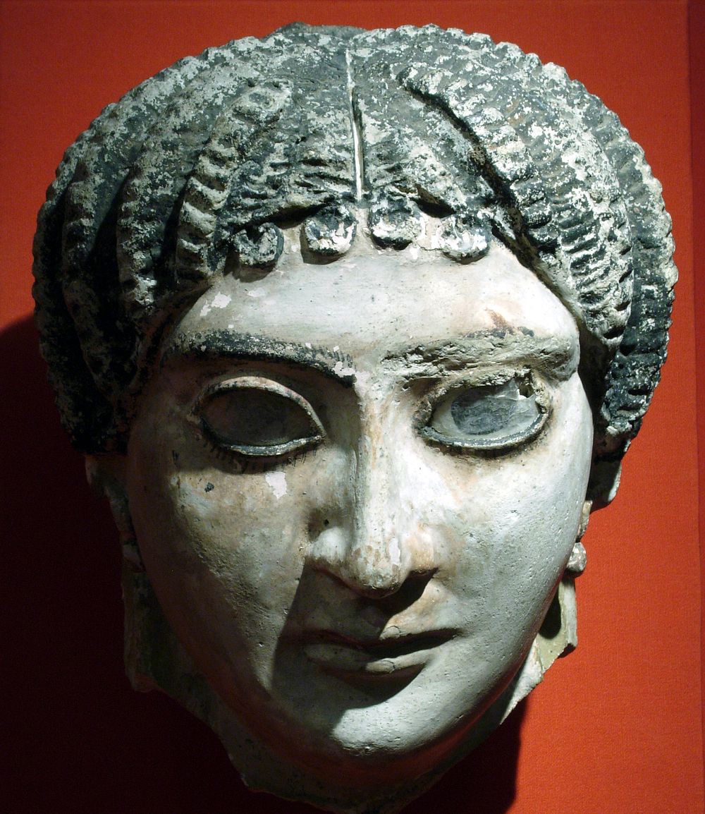 Mask of a woman with radiating waves of hair