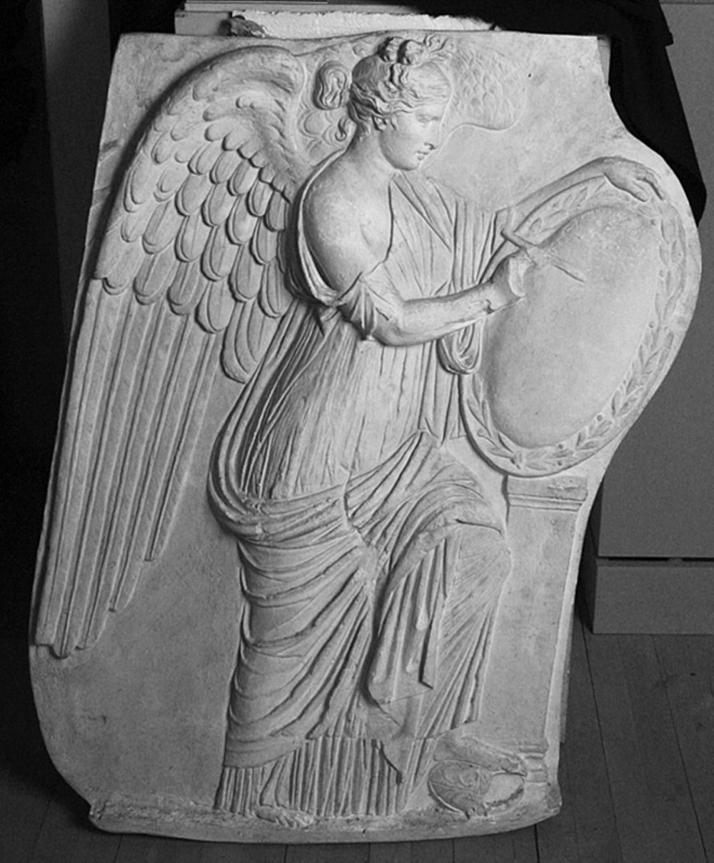 Victory goddess Victoria writes on shield