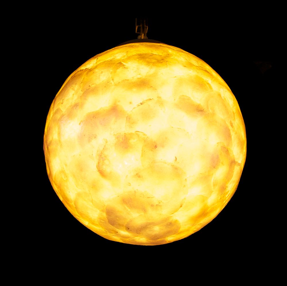 A spherical glass decorative lamp, outside of a "café" in Paris