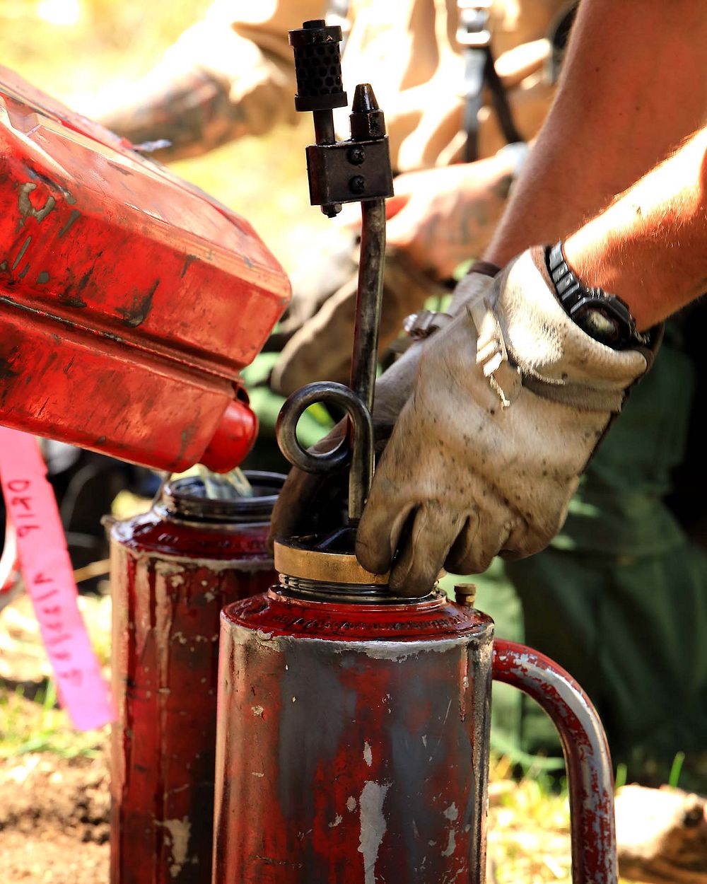 Fuels Management, Drip TorchesIn this photo firefighters are preparing drip torches to be used in a fuels management…