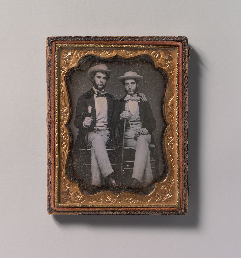 [Two Seated Young Men Holding Ivory-topped Walking Sticks]