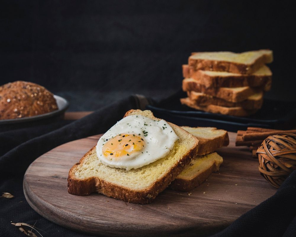 Free white toast with fried eggs on wooden board image, public domain food CC0 photo.