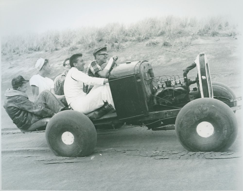 Men driving an antique car. Siuslaw National Forest Historic Photo. Original public domain image from Flickr
