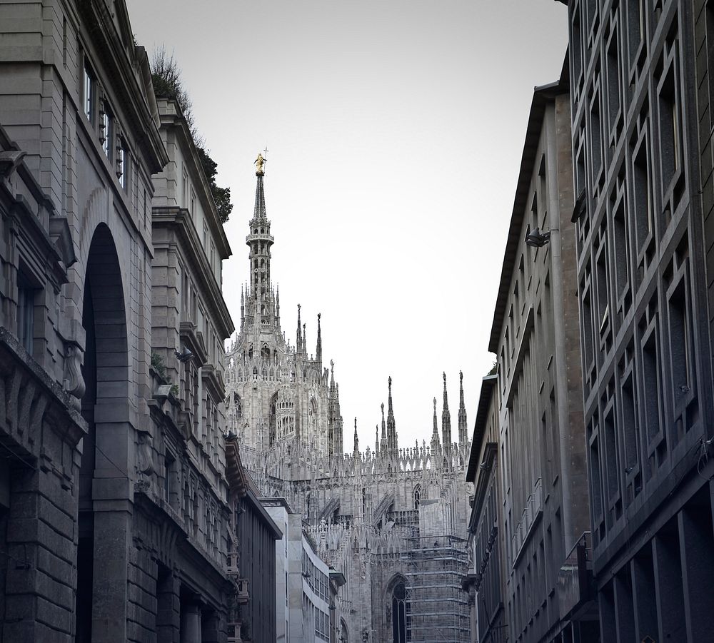 View of buidings, Gothic architectural church and sky in alley in Milan, Italy