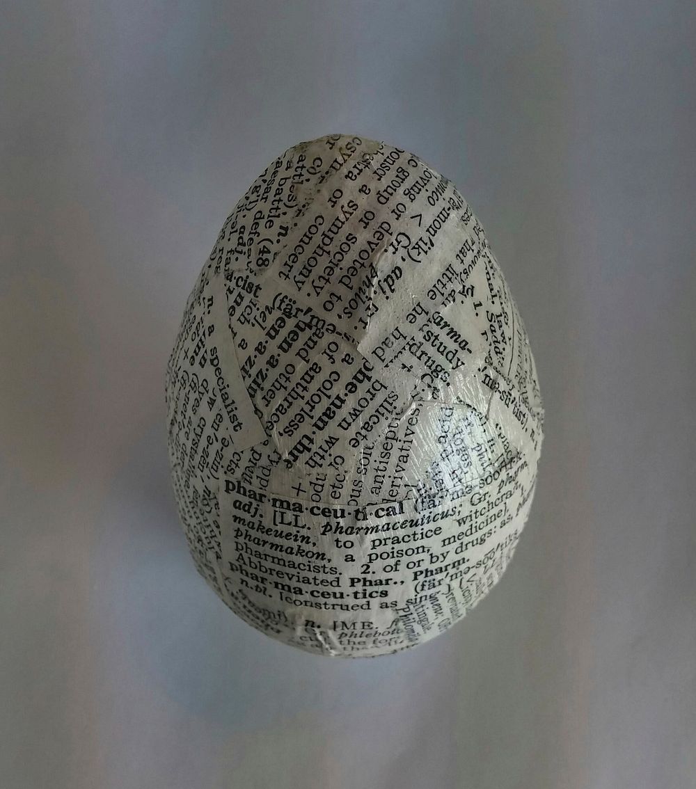 Closeup on newspaper decoupage egg. Free public domain CC0 image.