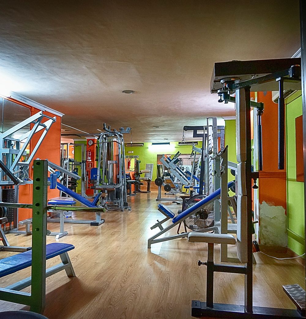 Gym full of machines and equipment. Free public domain CC0 photo.