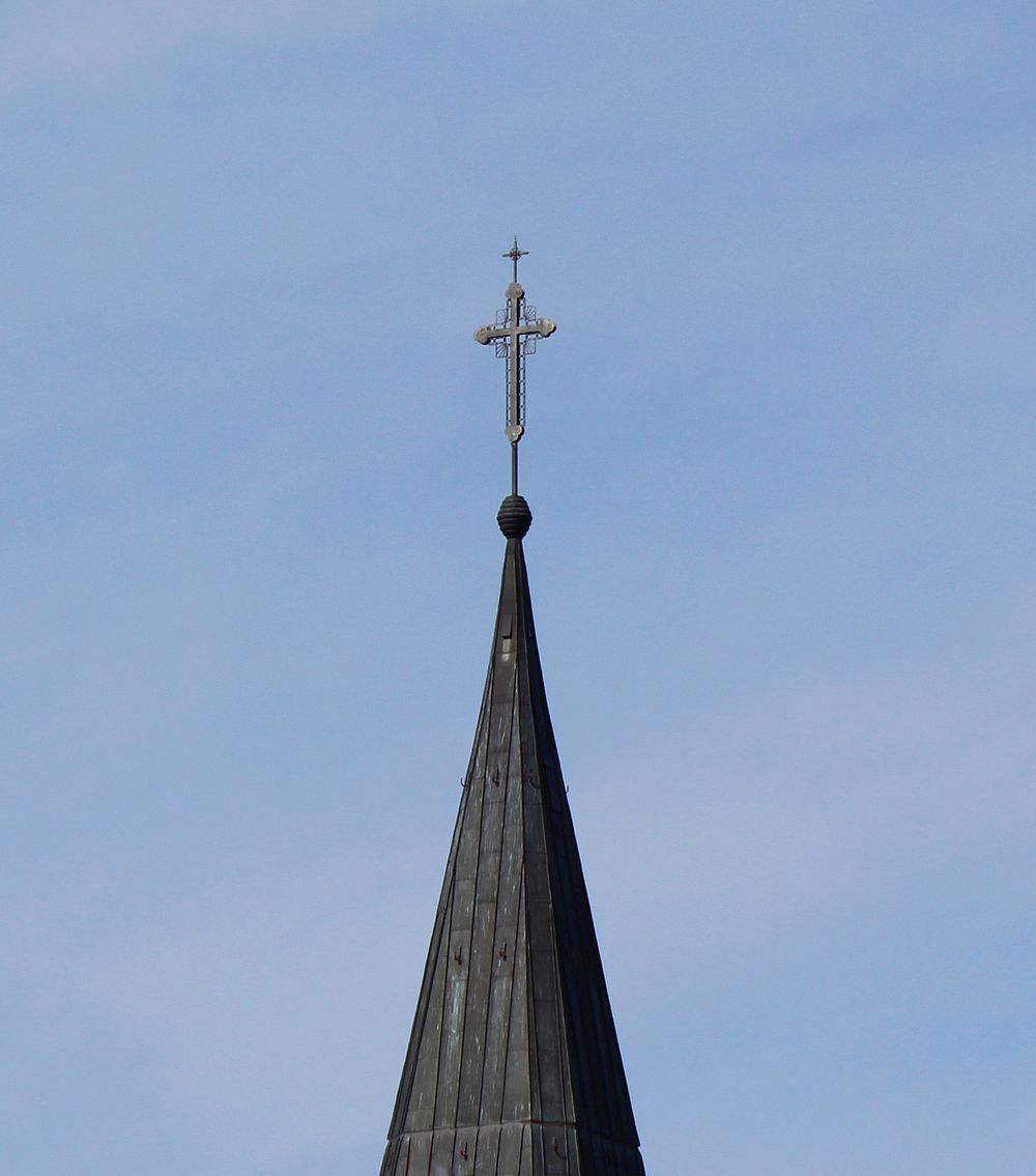 Church building steeple with a cross. Free public domain CC0 image.