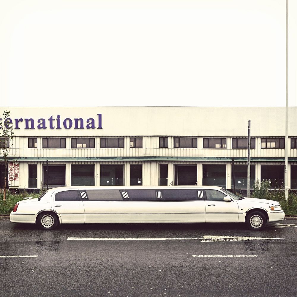 Limousine parked in front of a hotel. Free public domain CC0 photo.