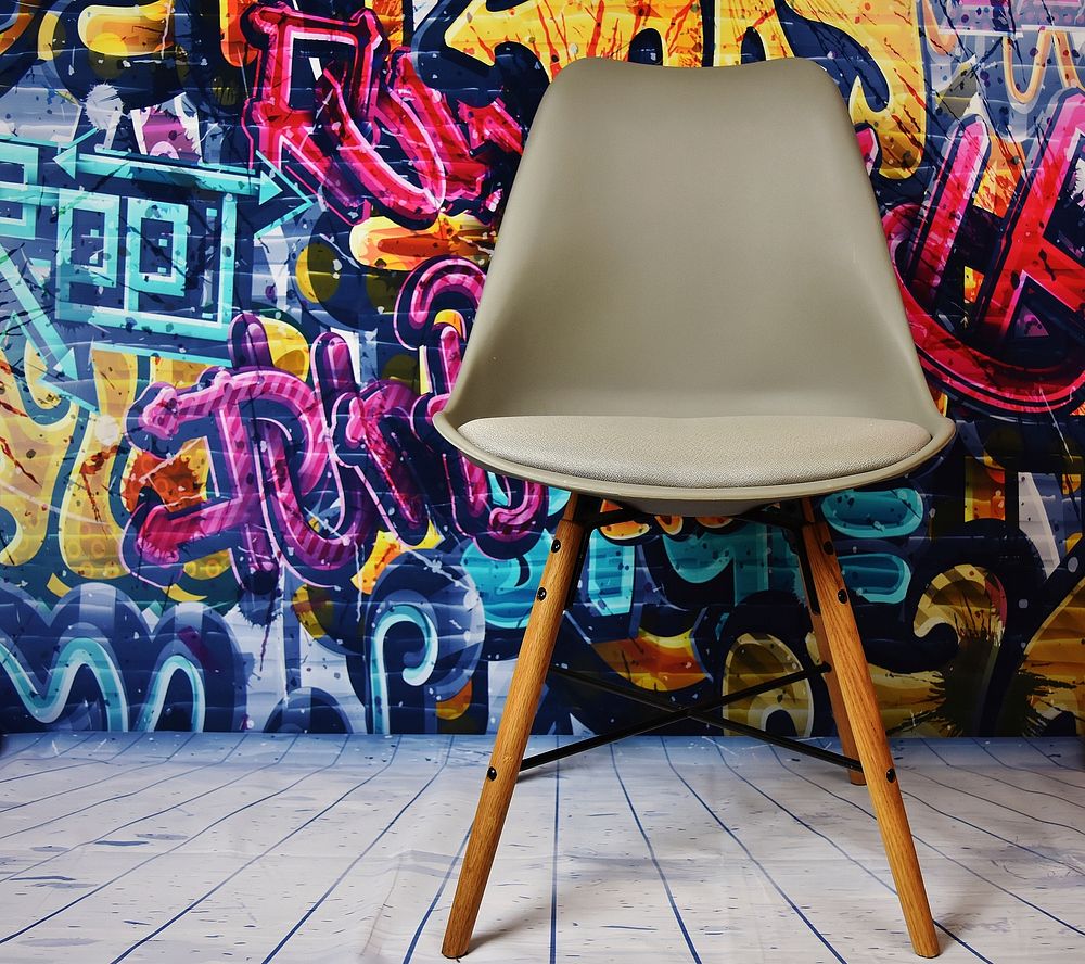 Free chair in front of street art photo, public domain art CC0 image.