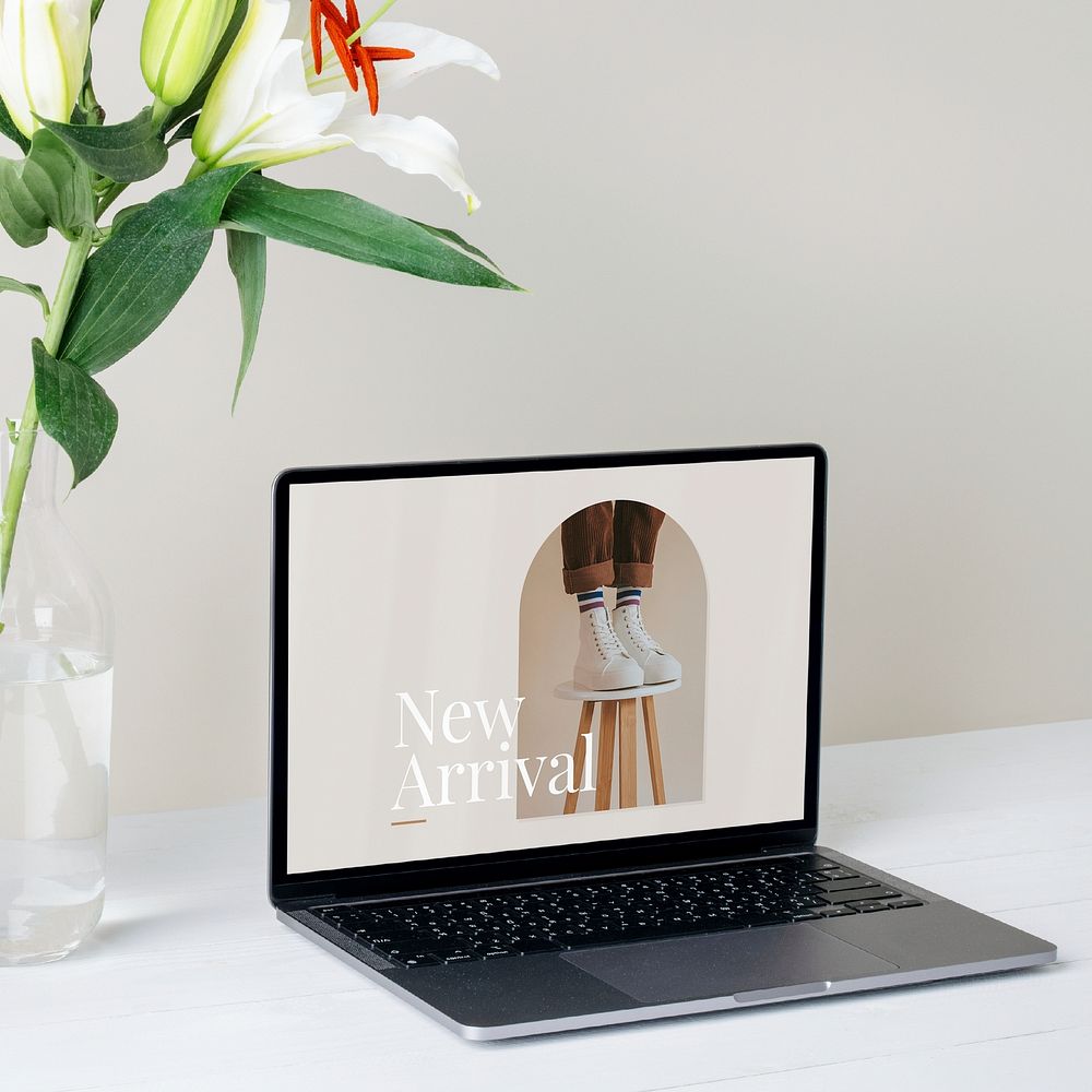 Laptop screen showing online shop website, minimal home office