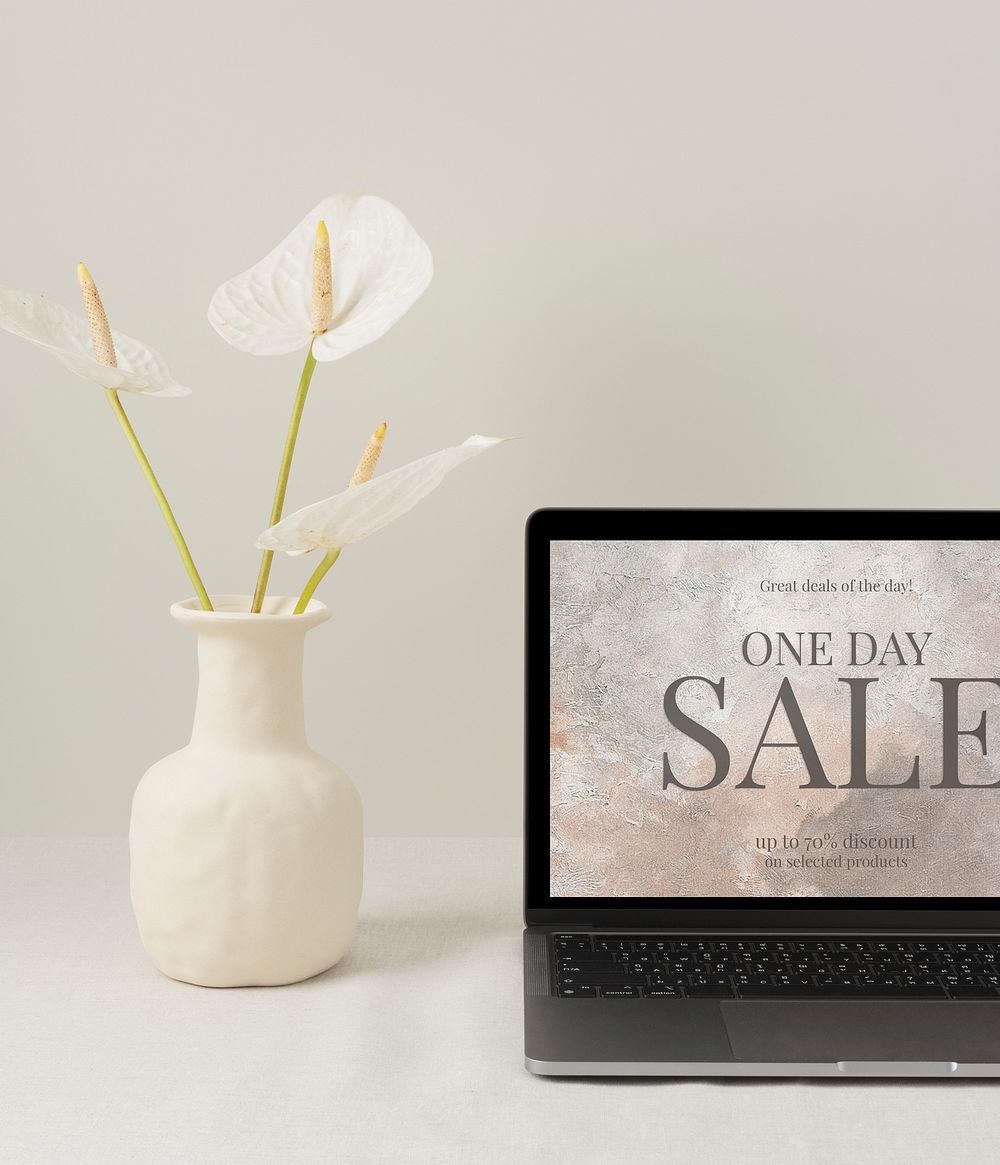 Online shop sale ad on a laptop screen, modern home interior