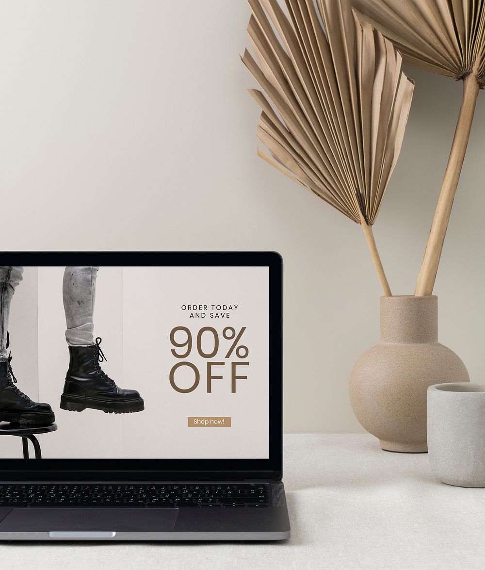 Online shop sale ad on a laptop screen, modern home interior