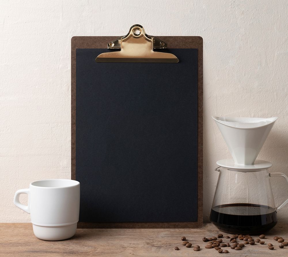 Blank black paper on clipboard, coffee lover workspace