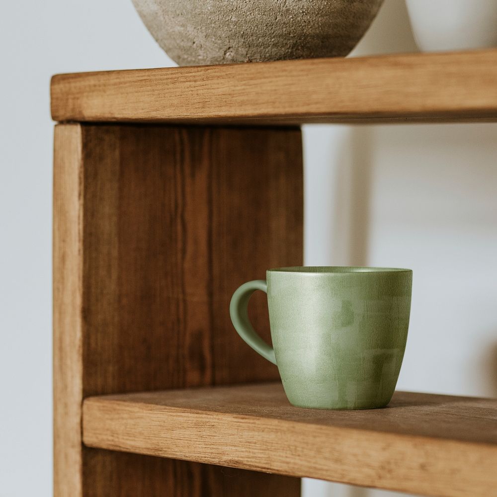Handmade cup on wooden shelf, home decor