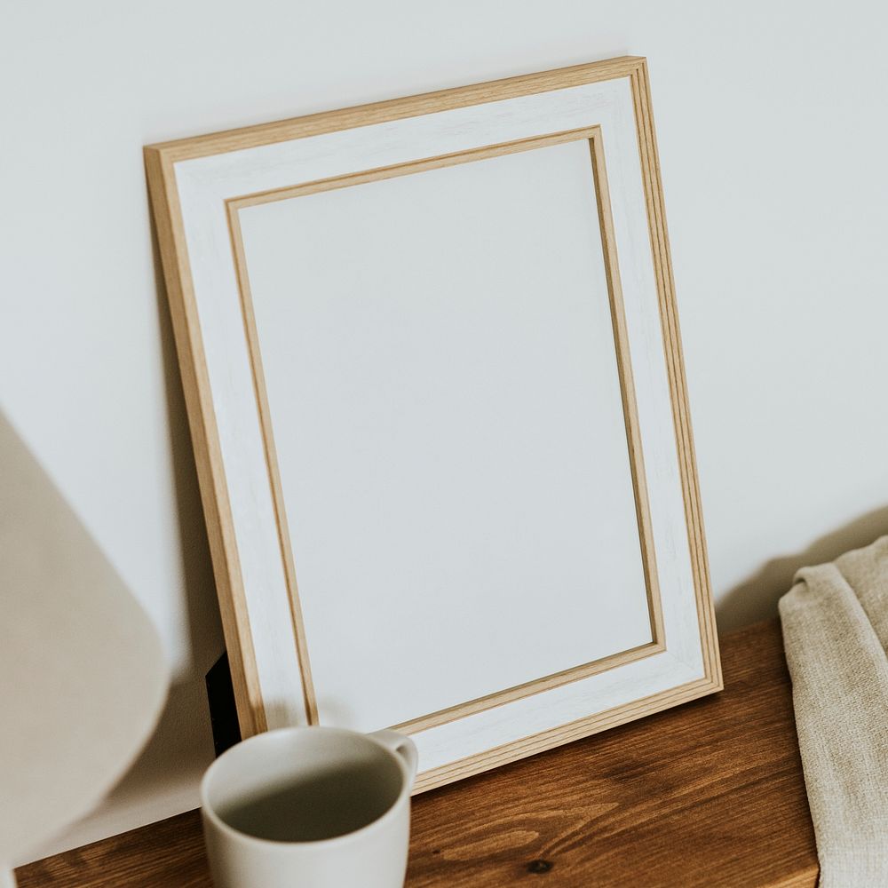 Aesthetic empty frame on wooden shelf