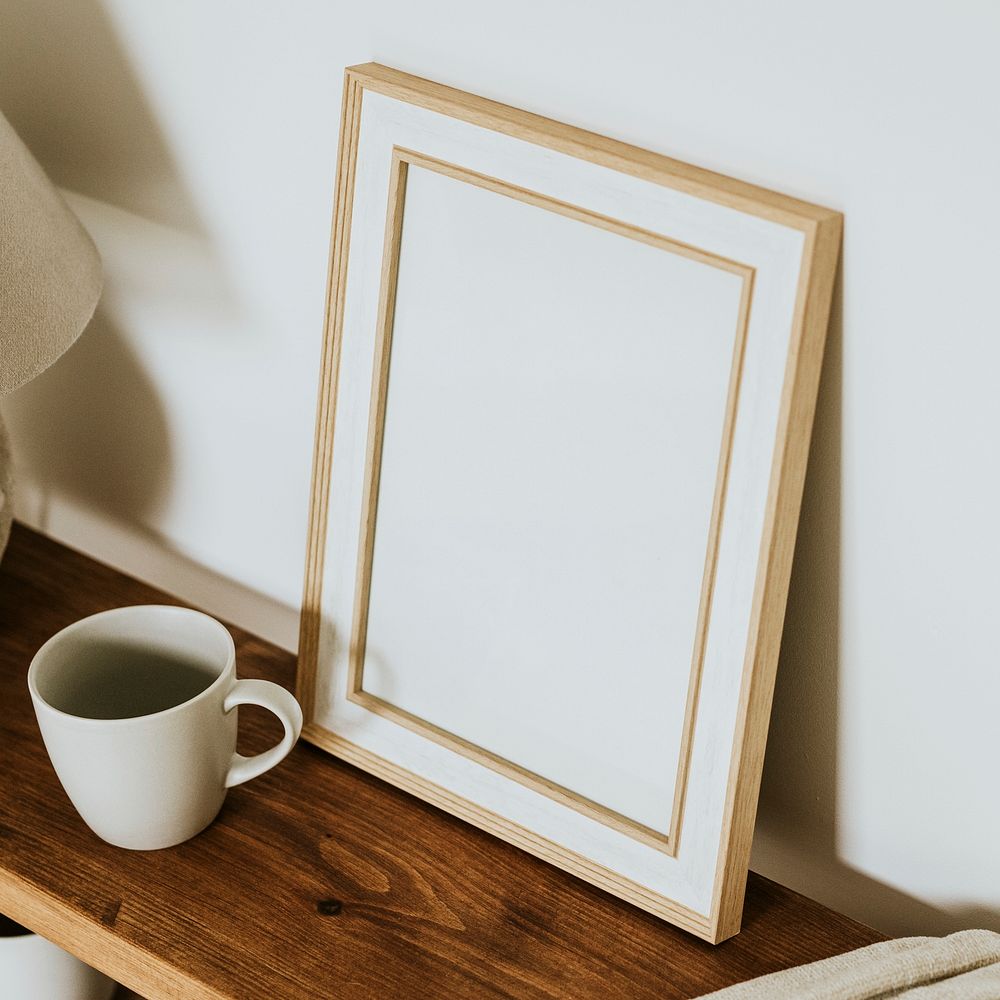 Aesthetic empty frame on wooden shelf