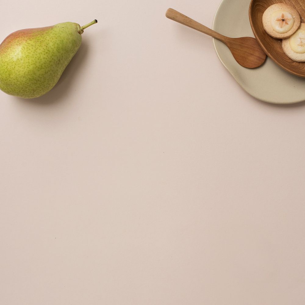 A pear and cookies on the table