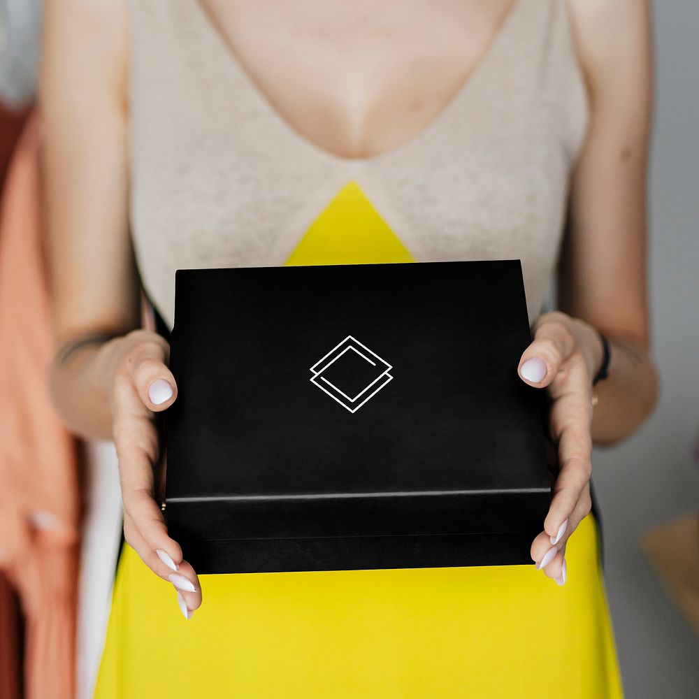 Woman displaying a black minimal box