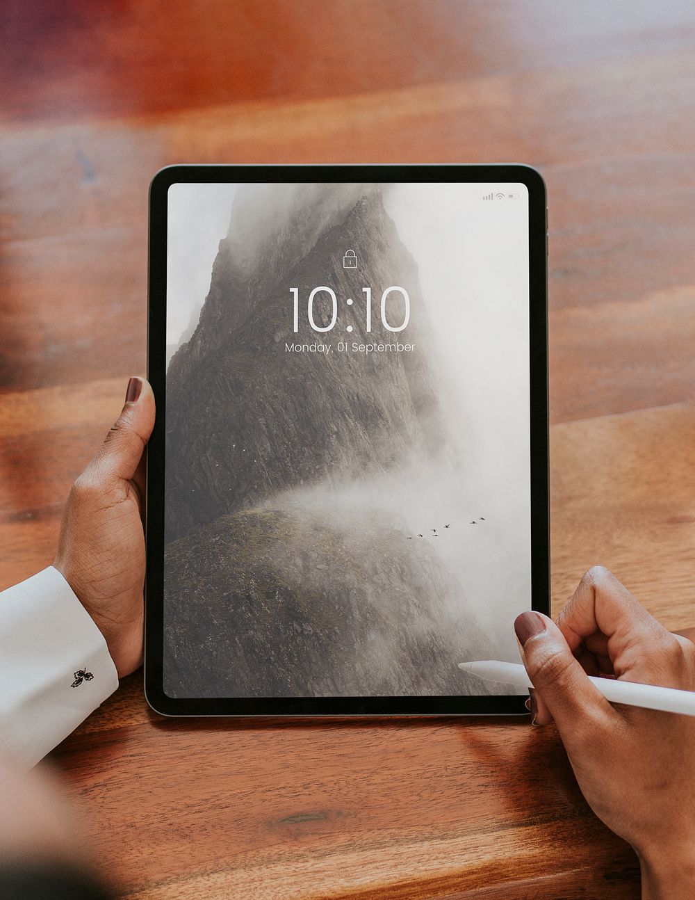Business person using a wireless stylus with a digital tablet mockup in a meeting
