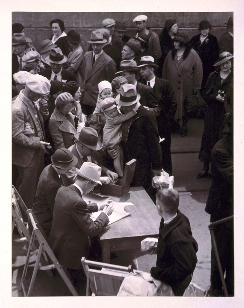 [Adults and children registering as ship passengers at dock in San Francisco]. Sourced from the Library of Congress.
