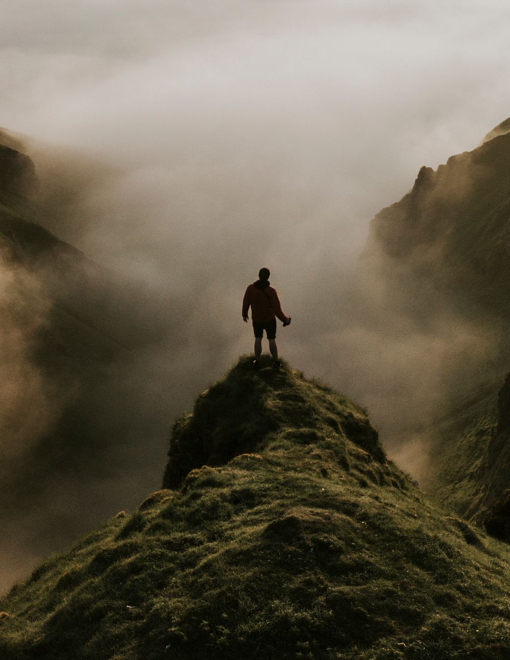 Man standing on a misty cliff background