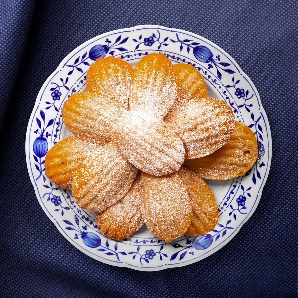 Madeleine biscuits on a plate, food photography, flat lay style