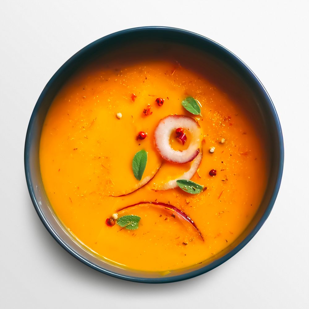 Orange soup in a bowl, food photography, flat lay style