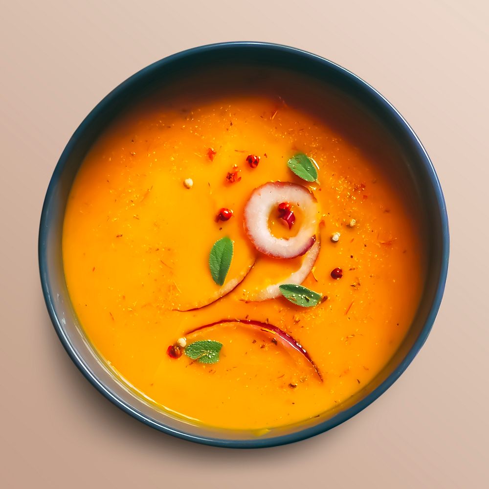 Orange soup in a bowl, food photography, flat lay style