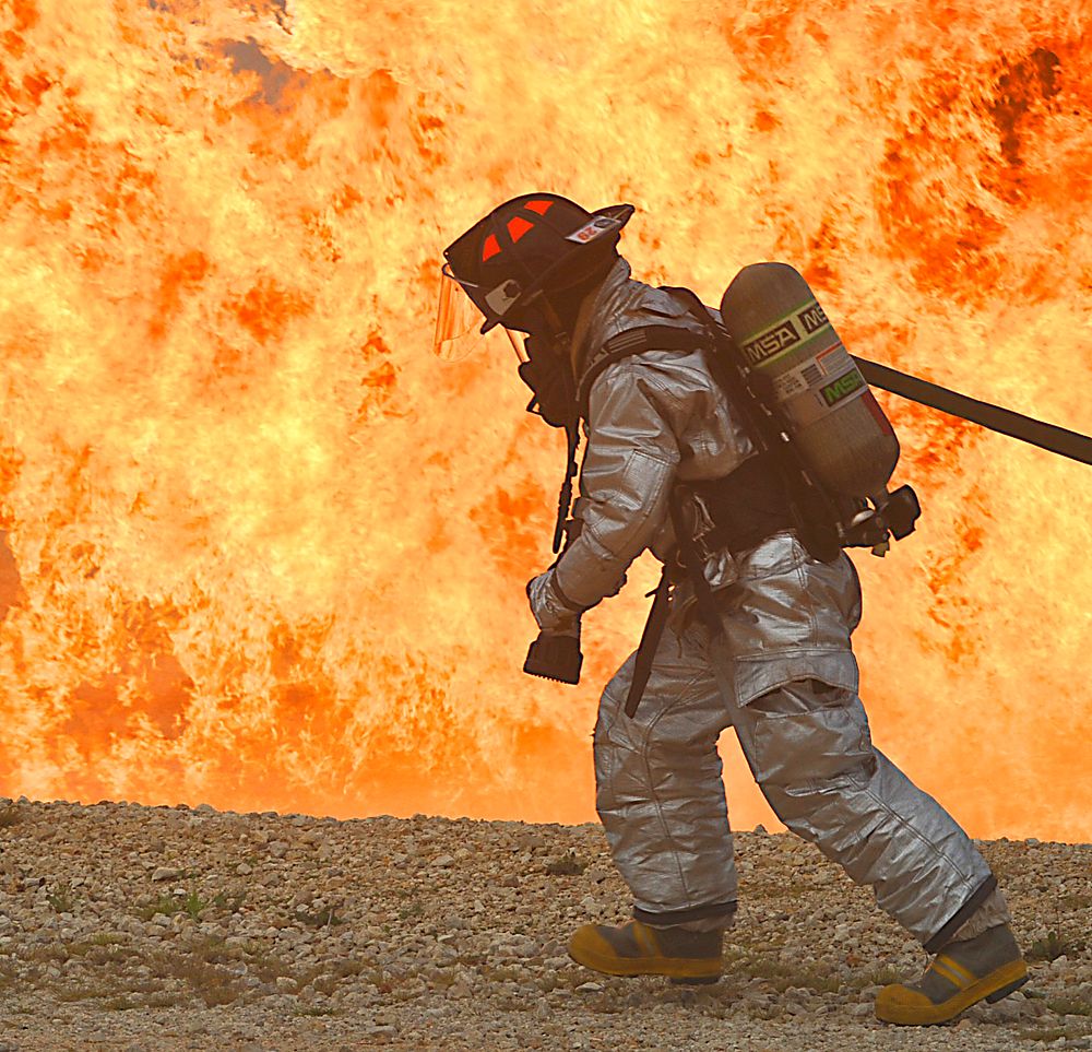 U.S. Air Force Senior Airman Kenneth Blum prepares to extinguish an aircraft fire Oct. 27, 2010, during an aircraft accident…