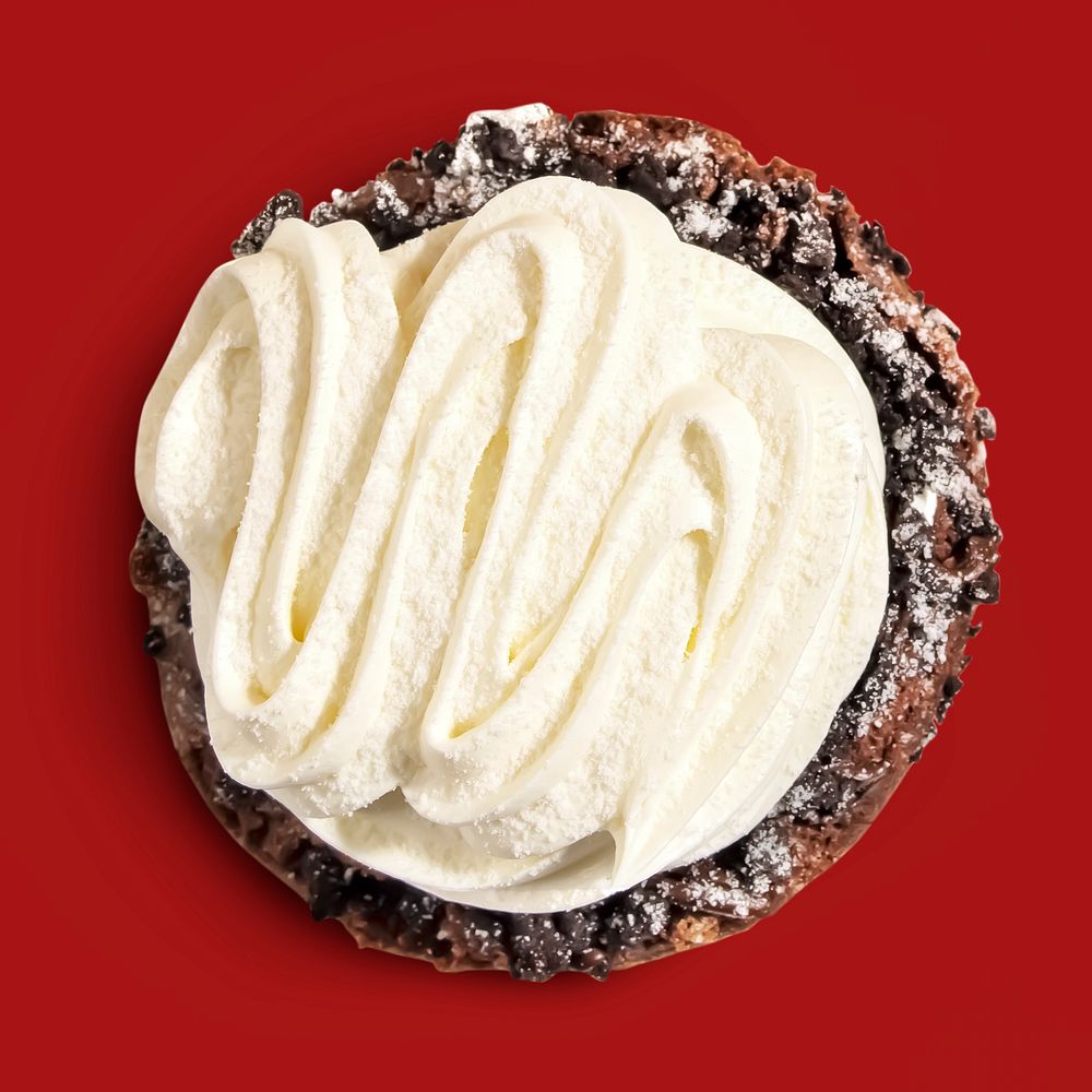 Filled frosted donut on red background, food photography