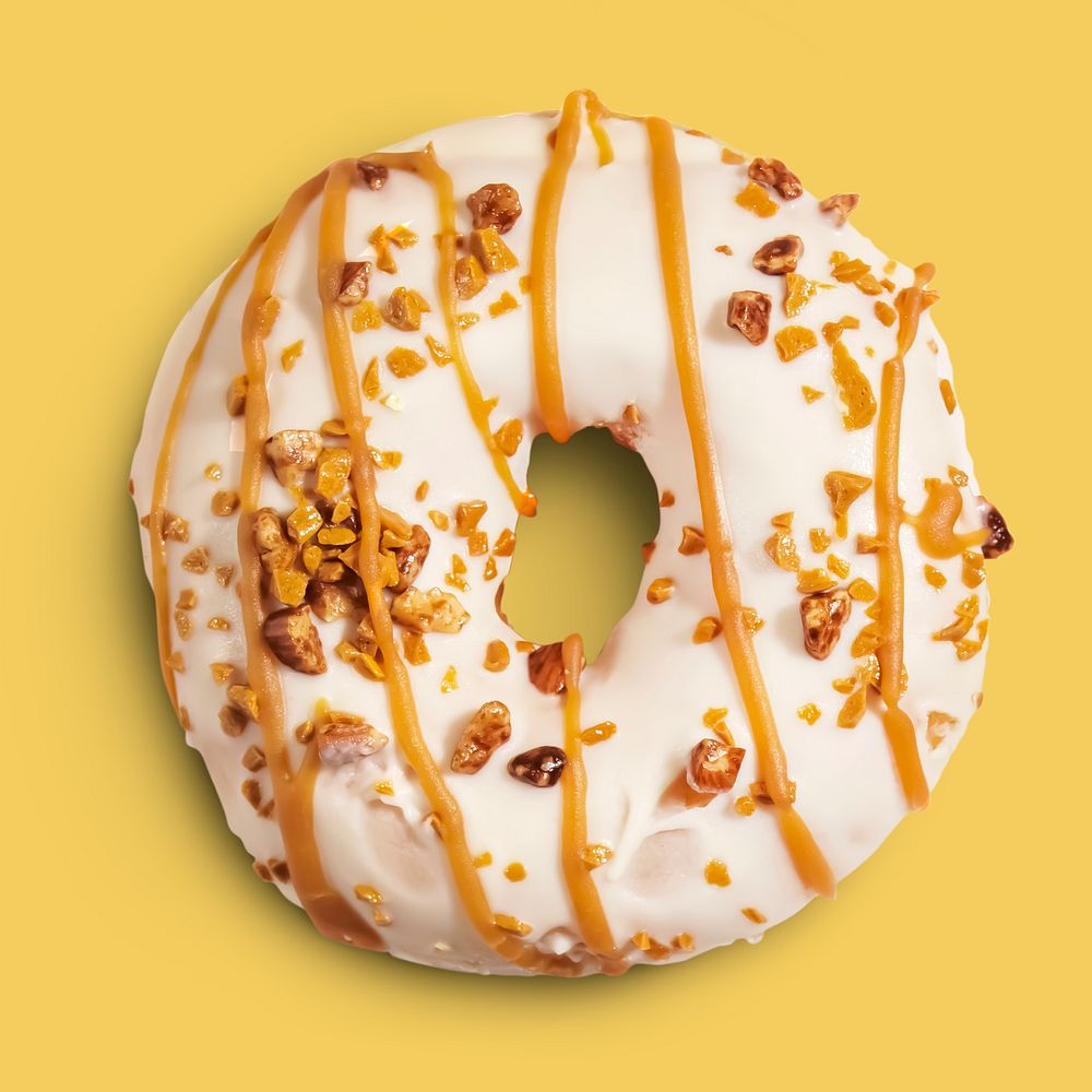 Frosted donut on yellow background, food photography