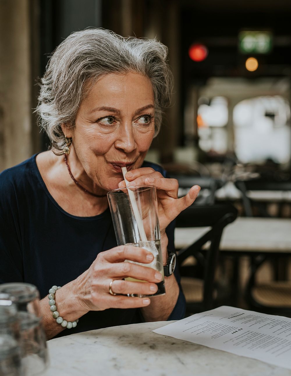 Woman drinking cocktail from straw