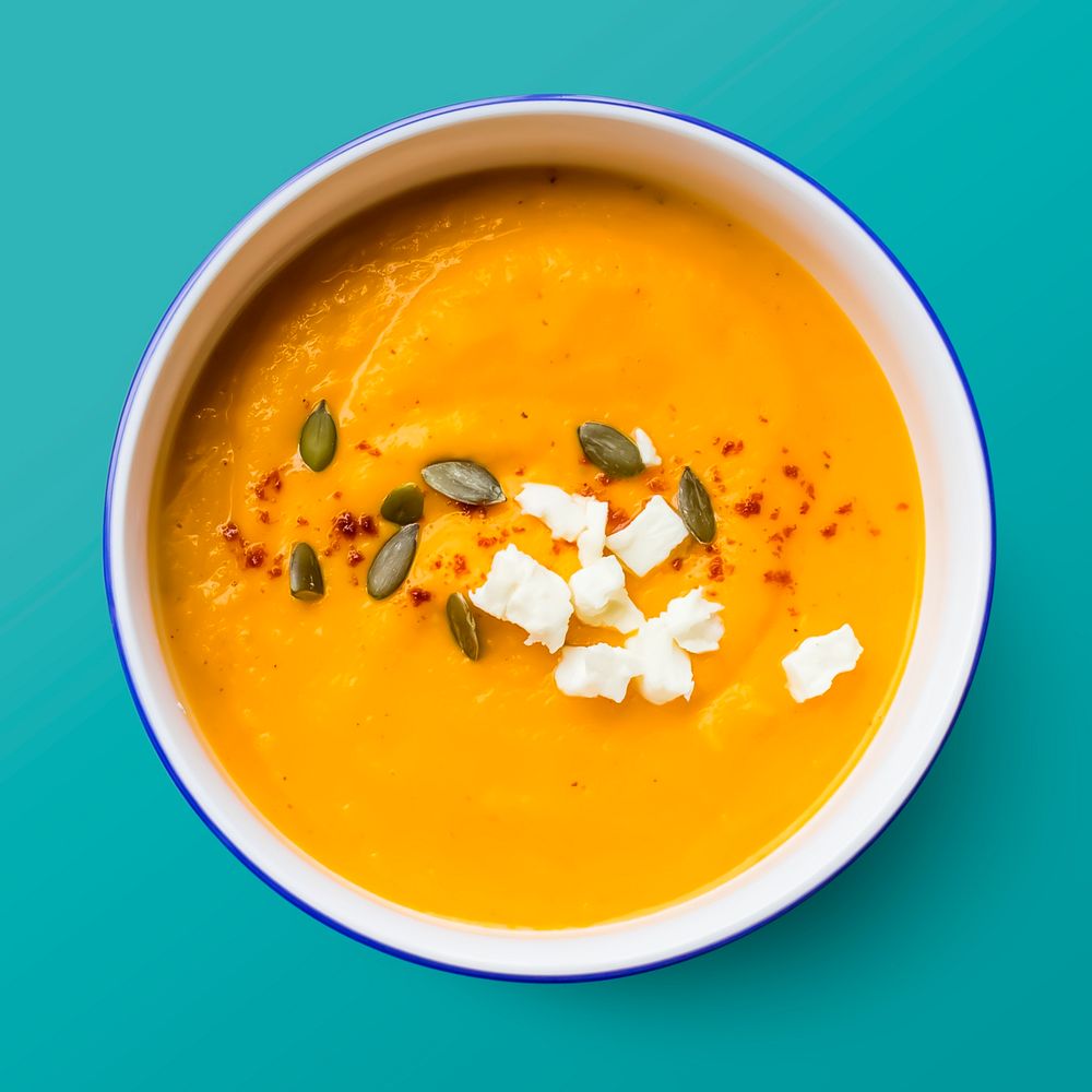 Pumpkin soup in a bowl, food photography, flat lay style