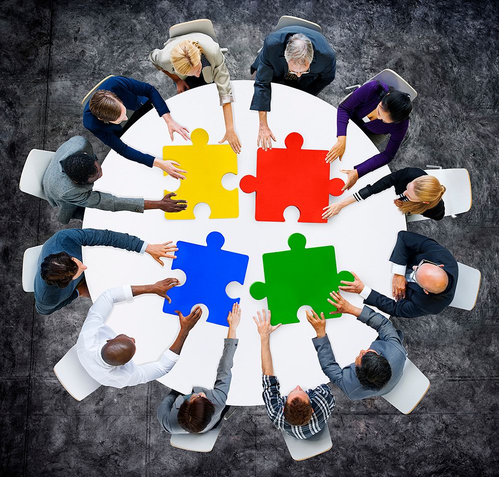 Business People with Jigsaw Pieces for Connection Concept