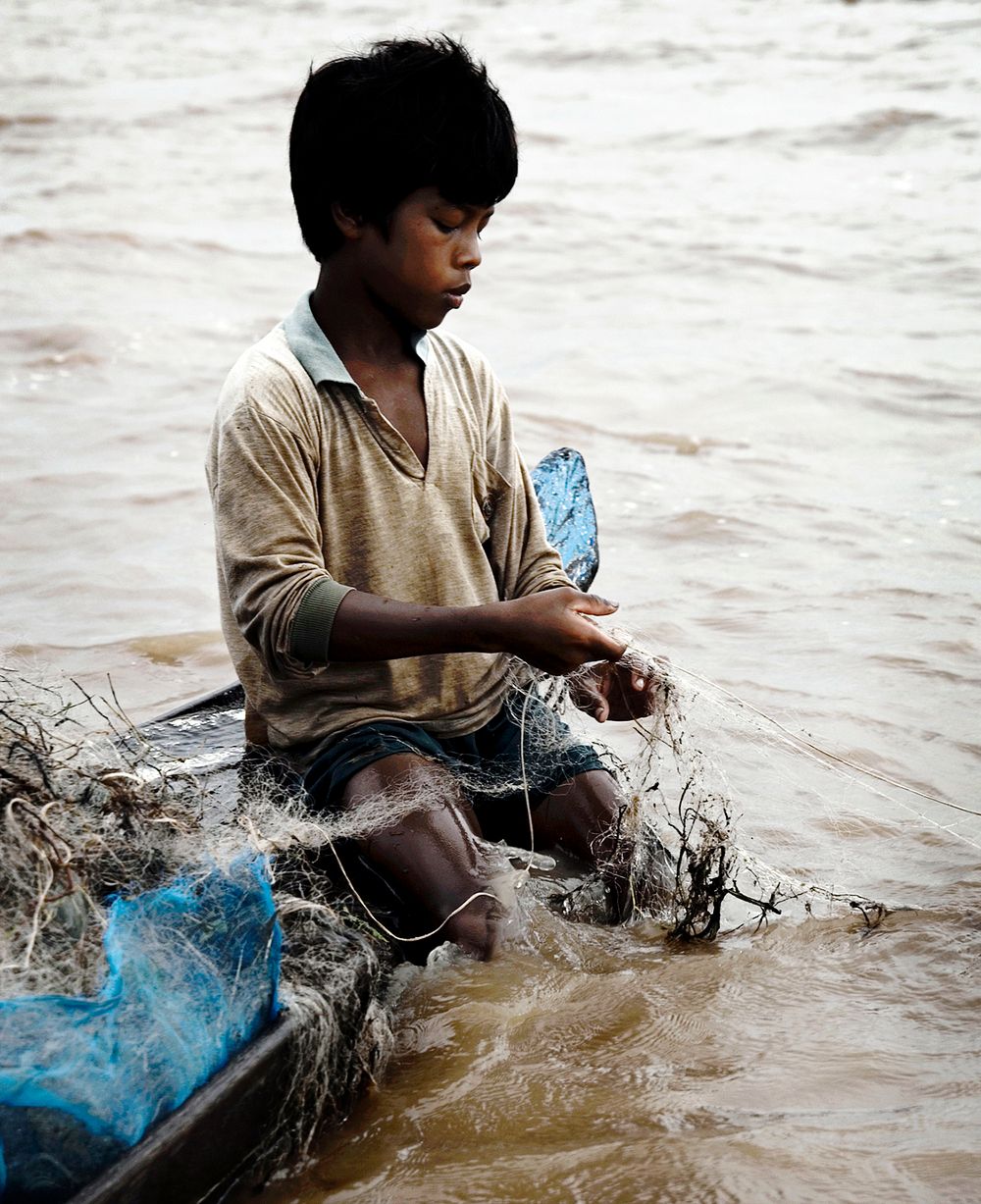 Cambodian boy fishing in the river